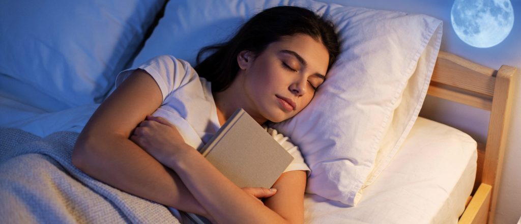 Peaceful Young Adult Sleeping While Holding a Blank Hardcover Book After Evening Reading Promoting Healthy Sleep, Relaxation, Learning and Mental Wellness